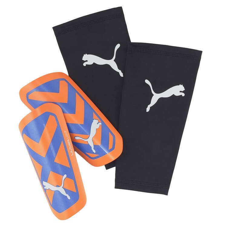 PUMA Ultra Light shin guards in orange and blue with black compression sleeves.